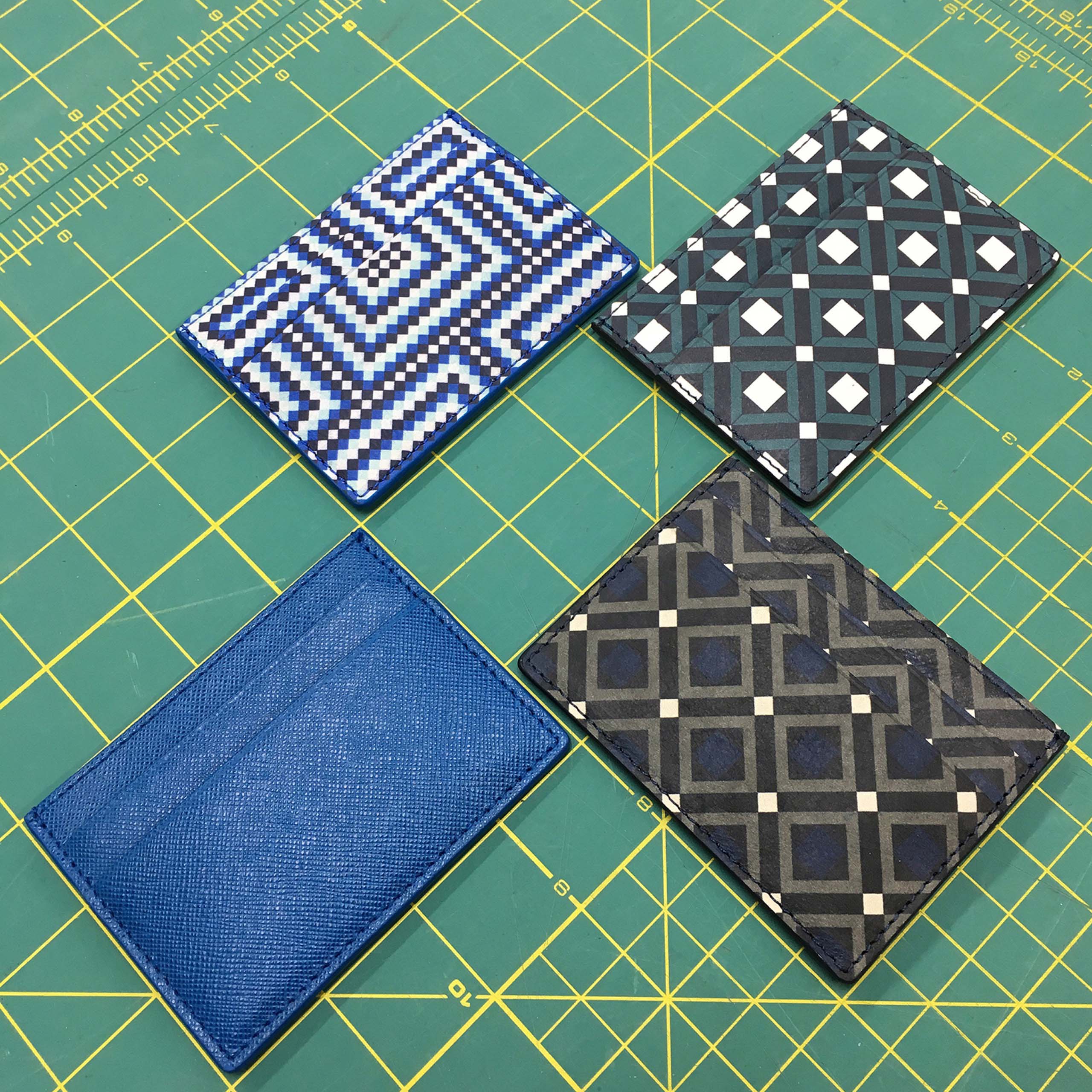 MARK / GIUSTI Italian leather card holders in mosaic patterns arranged on a cutting mat