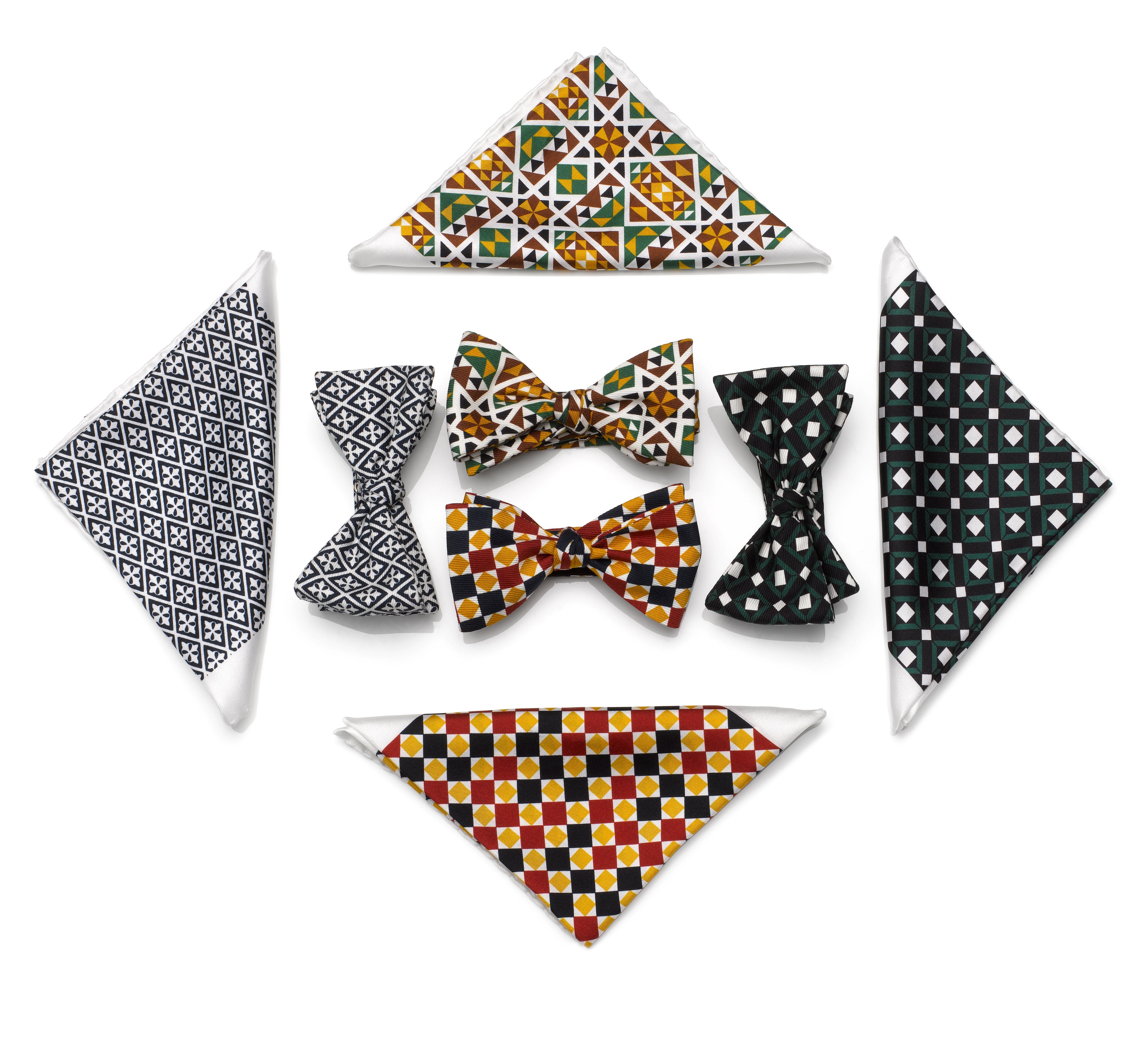 Geometric arrangement of MARK / GIUSTI silk ties, handkerchiefs and pocket squares featuring signature mosaic patterns in a coordinated display.