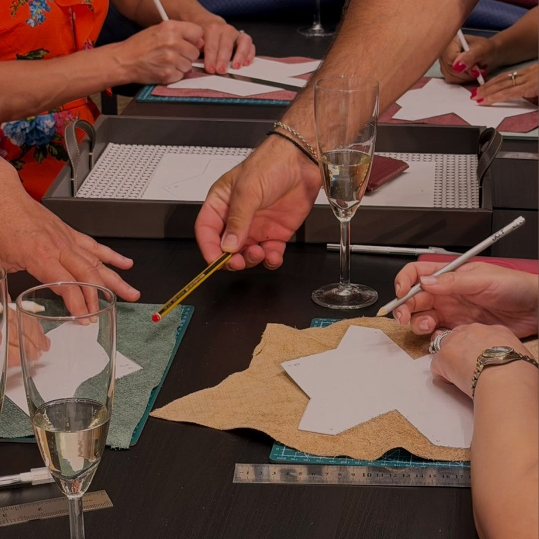 Guests at MARK / GIUSTI Leather Goods Store and atelier creating their own handcrafted wallet during the leather craft workshop