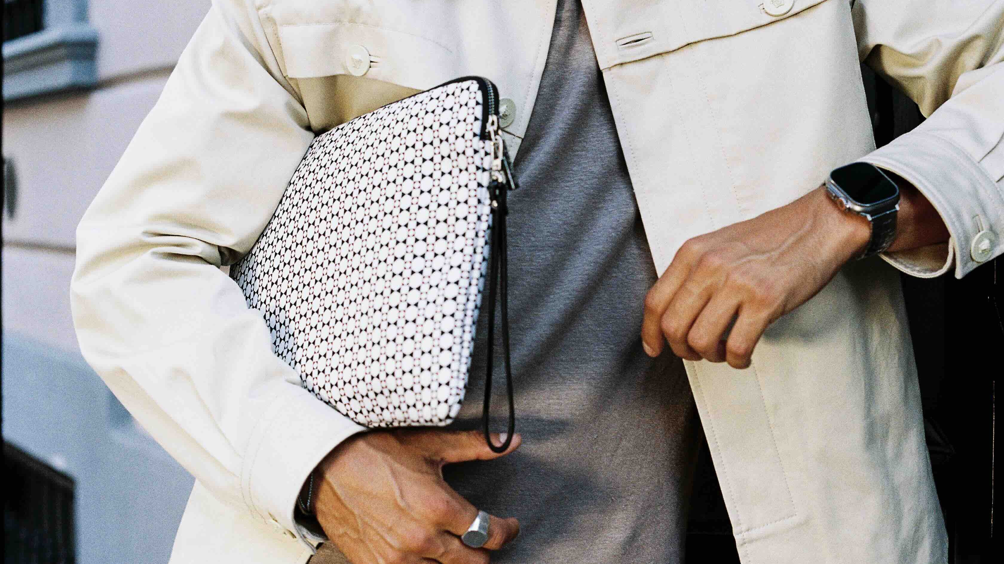 MARK / GIUSTI Brand Ambassador holding a mosaic printed Garibaldi laptop sleeve in Milano