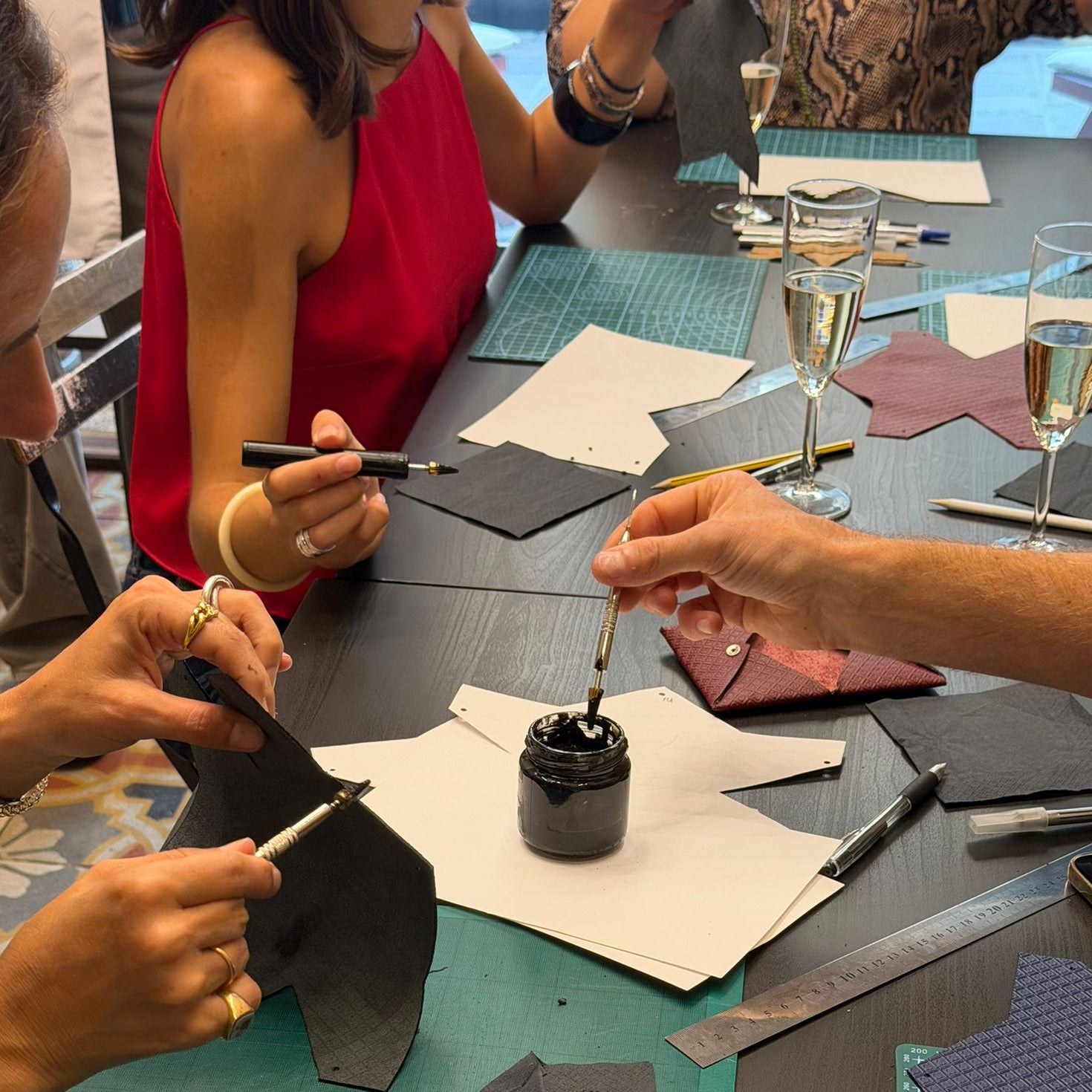 Guests at MARK / GIUSTI Leather Goods Store and atelier creating their own handcrafted wallet during the leather craft workshop