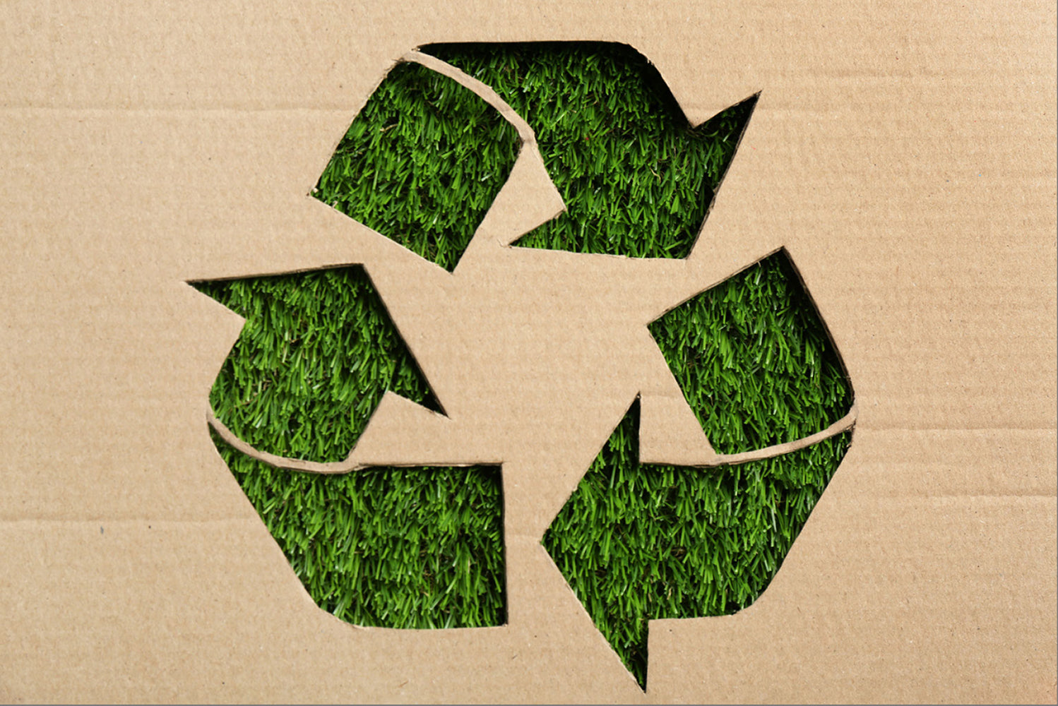 Recycled cardboard packaging with a green recycling symbol, highlighting MARK / GIUSTI's commitment to sustainable packaging solutions.