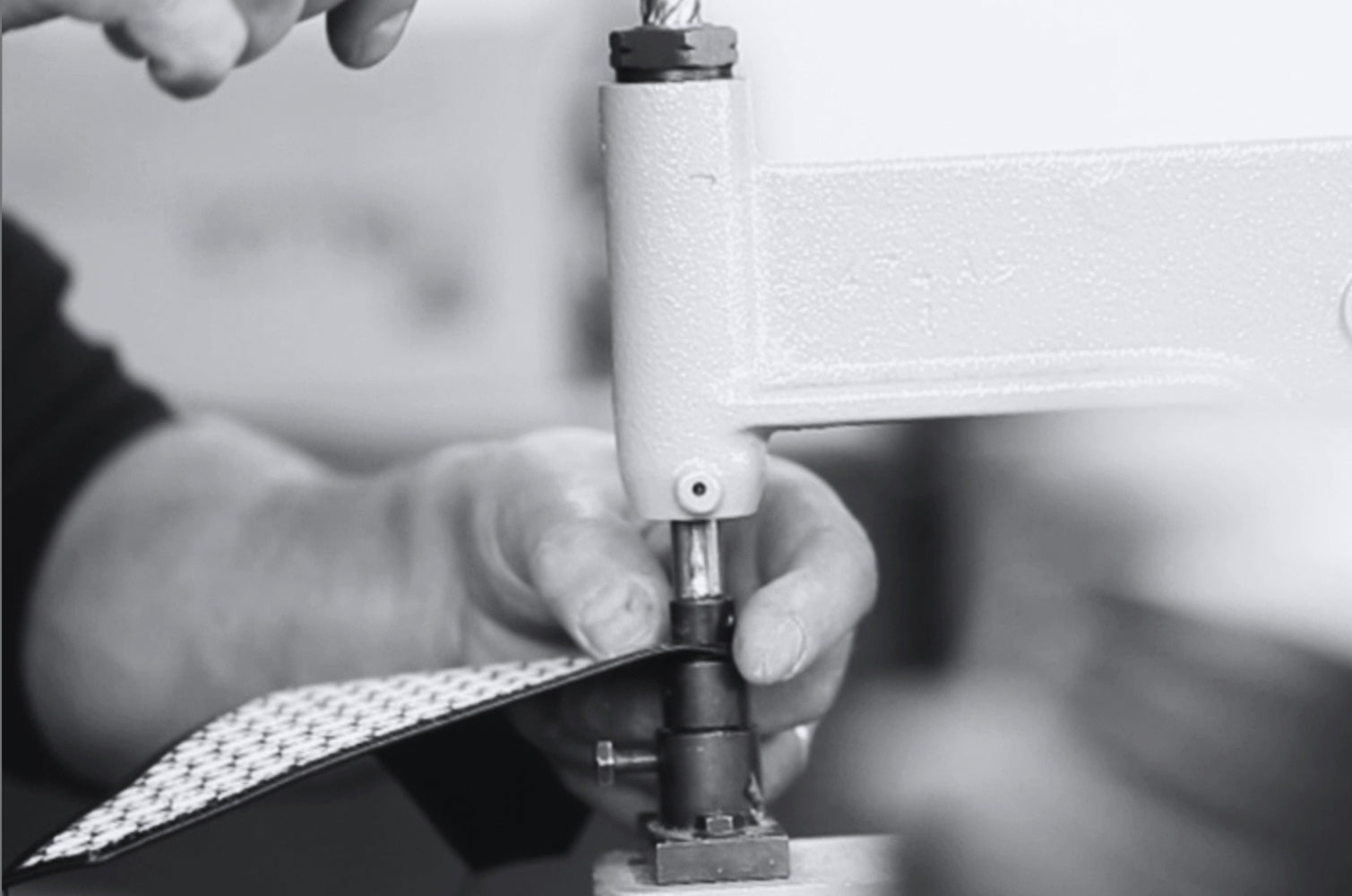 Artisan performing repairs to extend the life of MARK / GIUSTI's luxury accessories, supporting sustainable fashion practices