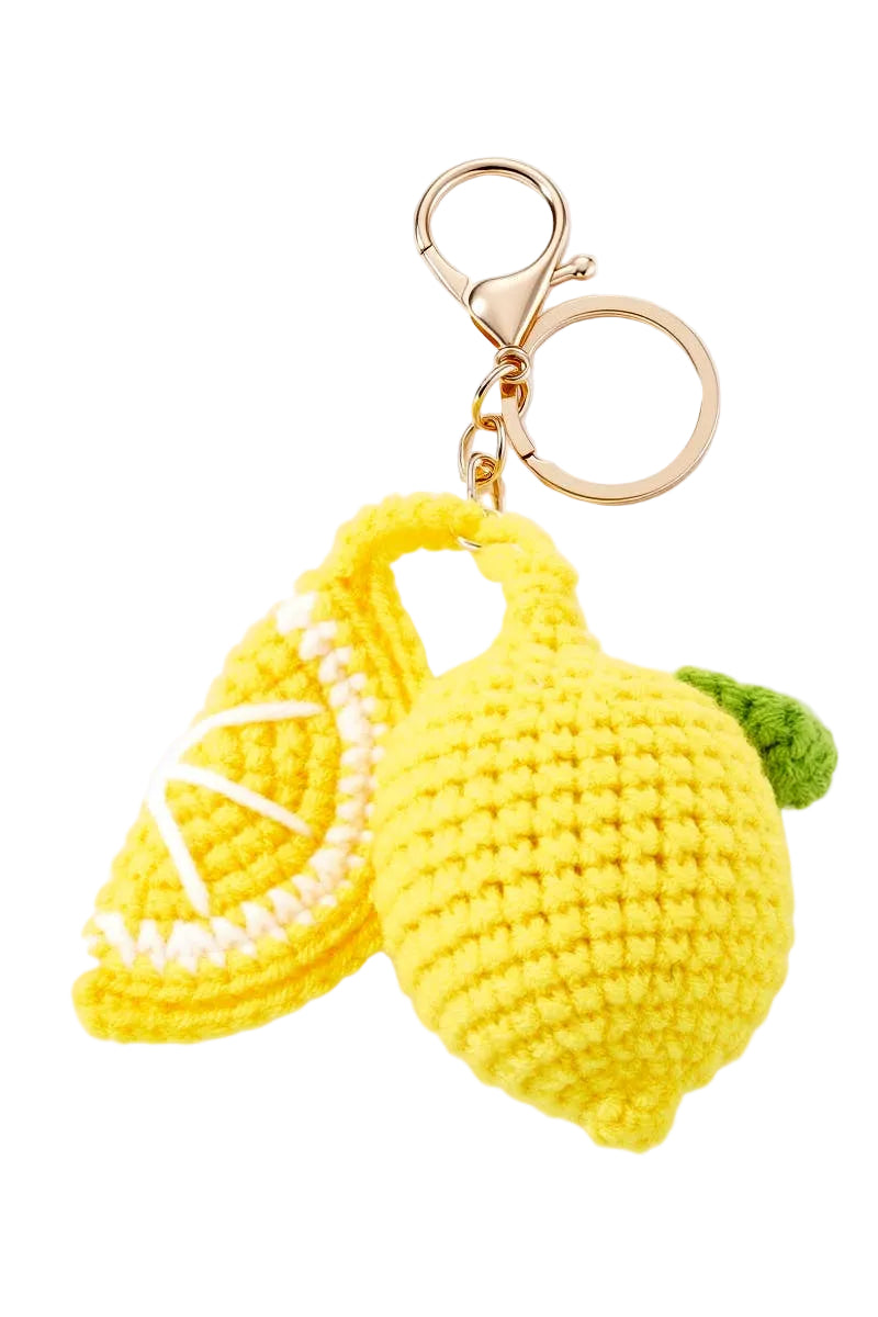 MARK / GIUSTI Crocheted lemon keychain with a gold ring on a white background